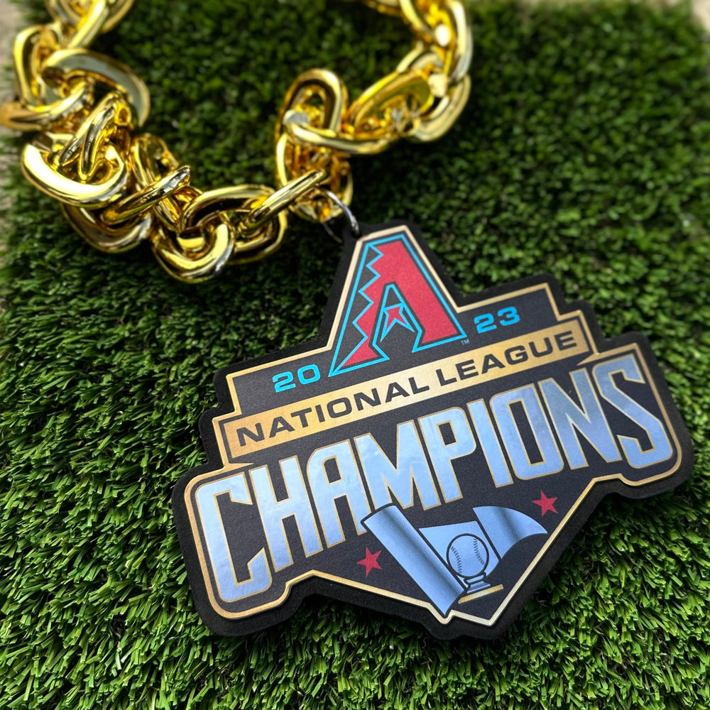 Gold plastic enlarged chain. Includes Alt A logo and 2023 National League Champions verbiage. Close-up.